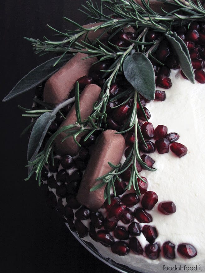 Rosemary and cinnamon cake with mascarpone frosting, pomegranate and gianduia creamy decorations